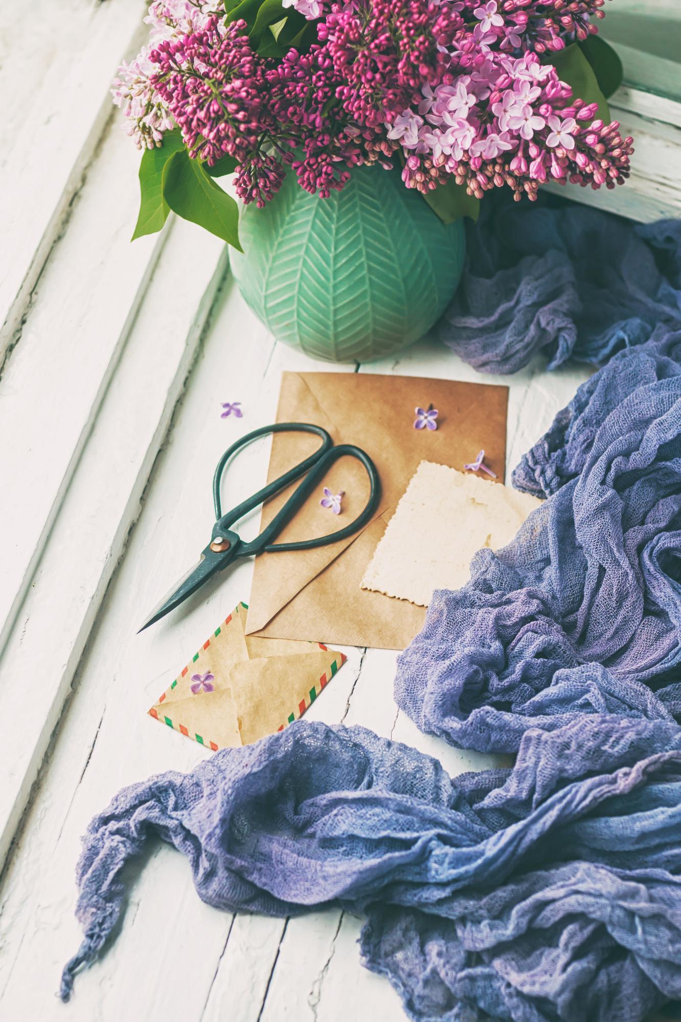 Editorial composition: embroidered garments on folded paper